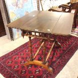 A c.1900 drop leaf table, with galleried friezes to either short end and pendants to corners, on