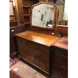 A 1920s/30s oak dressing table, the hinged mirror above a rectangular top with moulded edge above