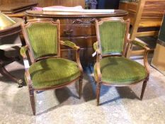 A pair of early 19thc French walnut fauteuil, each tapering back with foliate finial within outswept