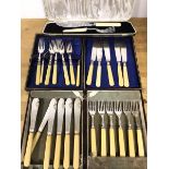 A boxed set of six bone handled fish knives and forks, in 1920s canteen and a further set, similar