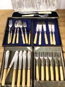 A boxed set of six bone handled fish knives and forks, in 1920s canteen and a further set, similar
