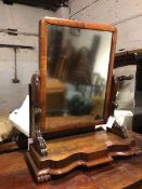 A Victorian mahogany dressing table mirror, the hinged mirror on moulded supports, the base with