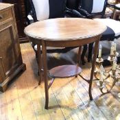 An Edwardian mahogany occasional table, with oval top, moulded edge, on straight supports united