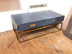 A contemporary campaign style blue painted coffee table, the rectangular top above two frieze