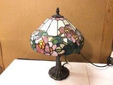 A Tiffany style table lamp with coloured glass floral shade, on naturalistic base (42cm)
