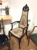 An Edwardian mahogany open armchair, the high back with intricately pierced crest above a tapestry