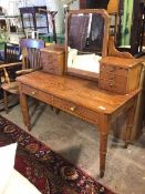 An Edwardian pitch pine dressing table, the hinged mirror supported by two pedestals each fitted