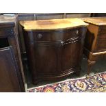 A reproduction Georgian inspired side cabinet, with serpentine top, fitted frieze drawer and two