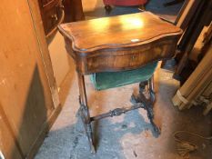 A 19thc rosewood games/work table, the serpentine hinged top opening to a chequerboard, above a