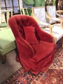 A Victorian bedroom chair in red upholstery, with button back, fringed apron, on turned front