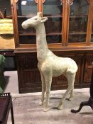 A papier mache giraffe of large proportions, the exterior covered with Victorian envelopes,