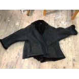 A stylish Geoffrey Beane, New York black sheepskin lady's coat (40cm across shoulders)