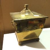 An Edwardian brass coal scuttle of square tapering form with drop handles to sides and swag detail