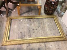 A gilt composition mirror of classical design (internal: 122cm x 61cm)