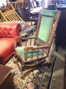 A 1920s/30s rocking chair with upholstered top rail, back and seat, on a sprung rocking mechanism,