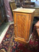 A Victorian satin birch bedside cabinet, the moulded top above a single panel door with shelf to
