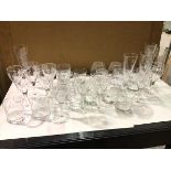 A large collection of glassware, all etched with foliate decoration, including six champagne