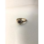 A 9ct gold cluster ring with garnet surrounded by pearls (M) (2.5g)