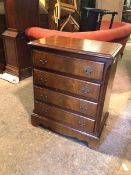 A reproduction Georgian style chest of drawers, the rectangular top with moulded edge above four