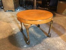 A Georgian inspired coffee table, the circular top above a plain frieze, on four cabriole supports