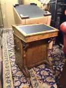 A Victorian davenport, the hinged sloped writing surface opening to an unfitted interior, with