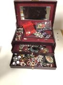 A collection of costume jewellery including brooches, earrings, necklaces etc., all in a jewellery