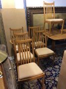 A set of six Ercol dining chairs, with two carvers, with banister backs, squab seat cushions over