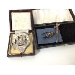 A Scottish silver brooch, with bird within an inscribed border, Spernit Humum (5.5cm) (25g) and a
