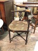 An Edwardian ebonised mahogany corner chair, the back with turned supports and pierced splats