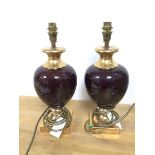 A pair of modern Valsan table lamps, of baluster form, with oxblood glazed bodies and gilt bases (