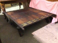 A Howdah style coffee table, the wooden top flanked by sheet metal panels, with matching sides and