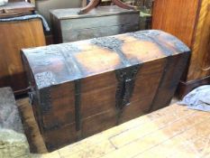 A 19thc Continental oak and iron bound trunk, the domed lid with pierced iron strapwork above a