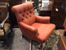 An Edwardian library armchair, the rolled top above a button back, rolled arms, in red upholstery (