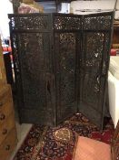 A 1920s Chinese three fold screen, the pierced panels with mythical birds and vine decoration,