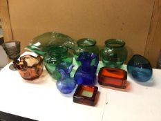 A collection of coloured glass including a green flower bowl of undulating form (13cm x 30cm x