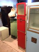 A vintage 1950s/60s tall kitchen cabinet, painted white and red, the top cupboard with glass