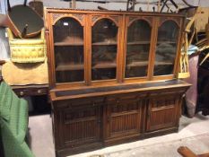 A large oak bureau bookcase with four doors enclosing adjustable shelved interior, on possibly