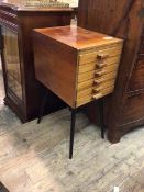 A mid century teak chest of drawers, the rectangular top above six long narrow drawers, on splay