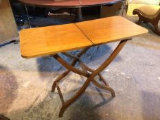 A late 19thc/early 20thc mahogany folding table, the rectangular top on a folding X frame with