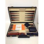 A travelling backgammon set (case: 5cm x 38cm x 25cm)