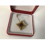 A 9ct gold pendant set central citrine within a diamond shaped frame, set seed pearls to corners (