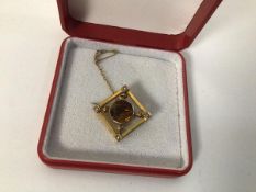 A 9ct gold pendant set central citrine within a diamond shaped frame, set seed pearls to corners (