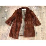 A fur coat (36cm across shoulders)