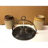 A cast iron skillet (with handle: 25cm x 33cm) and two glazed stoneware jars (3)