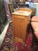 An Edwardian bedside cabinet, the rounded ledge back above a top with moulded edge, fitted single