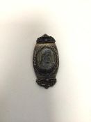 A late 19thc/early 20thc brooch in the form of a vertical navette with a carved stone bust of a
