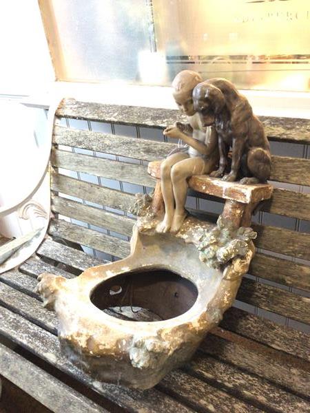 A composition fountain/bird bath top showing boy (lacking fishing rod) and dog figure gazing towards