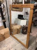 A large modern wall mirror in pine frame with moulded edge (136cm x 150cm)
