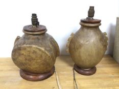 Two camel bladder lamps, both on a moulded circular base (taller: 39cm)