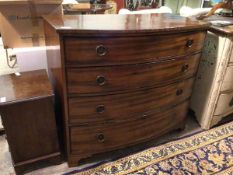 An early 19thc bow front mahogany chest, fitted four graduated drawers, ring handles, on shaped